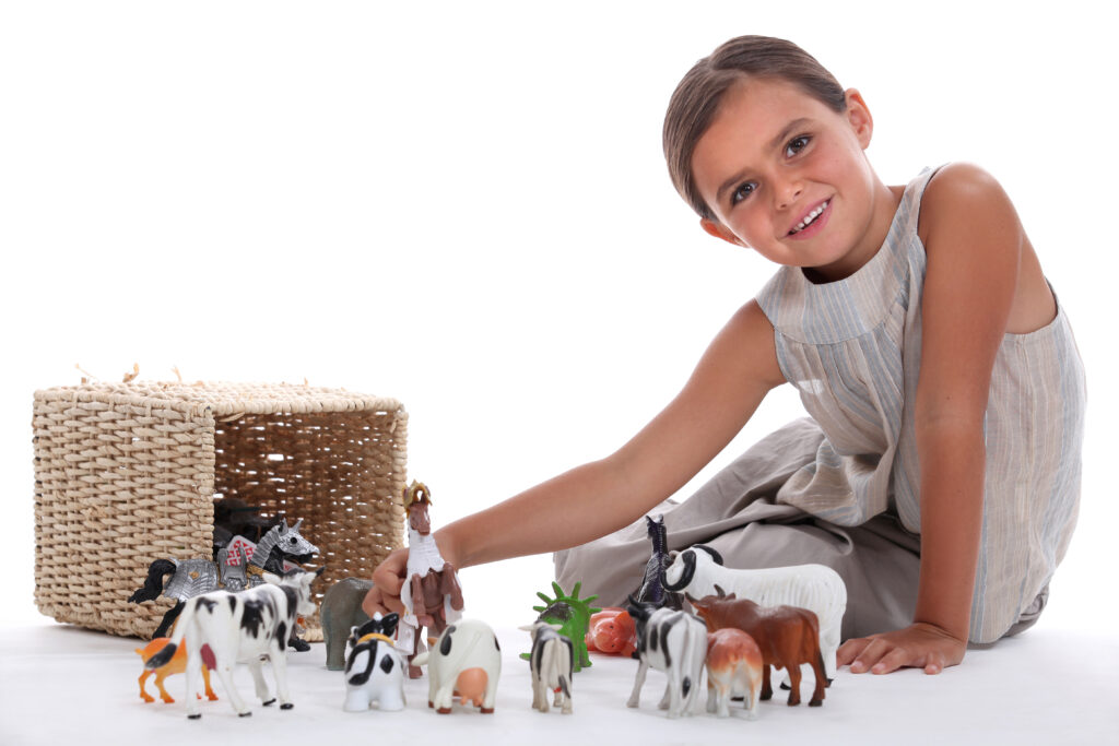 child with farm animal toys