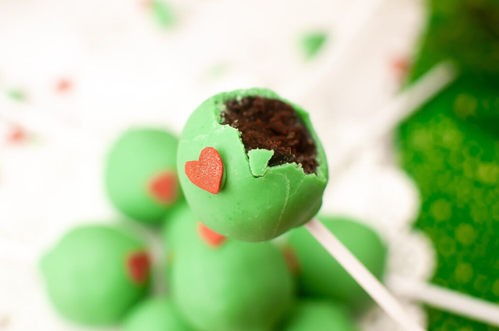 Grinch cake pops with a bite taken out