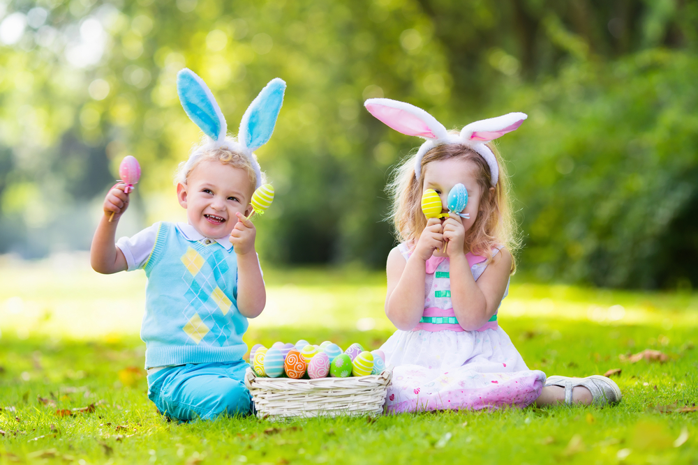 toddlers holding eggs from an Easter basket