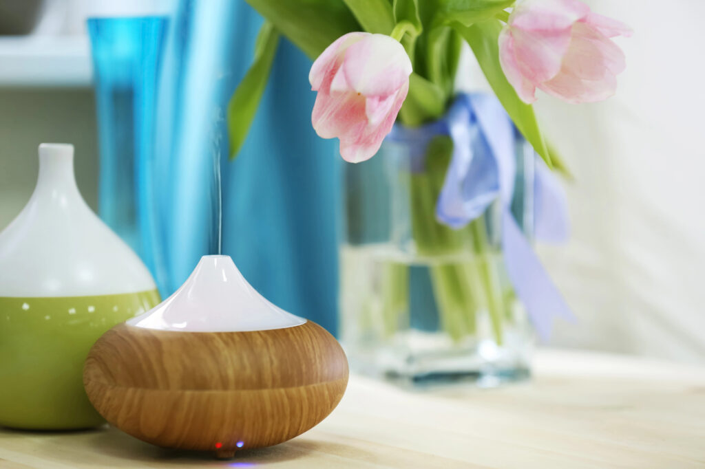 spring diffuser blend in a diffuser with pink tulips in the background